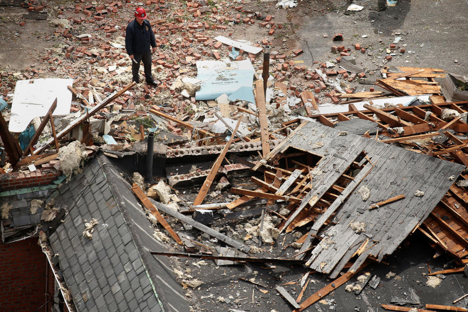 <p>An investigator stands amidst debris of a home that was destroyed by an explosion in the early morning in the Bronx borough of New York on Sept. 27, 2016. (Carlo Allegri/Reuters) </p>