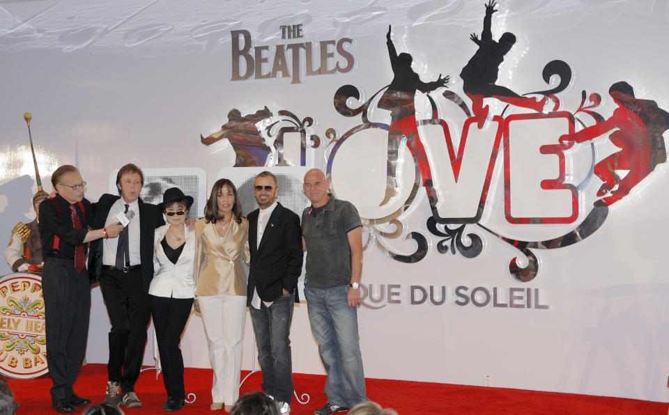FILE - From left, Larry King, Paul McCartney, Yoko Ono Lennon, Olivia Harrison, Ringo Starr and Guy Laliberte, founder of Cirque du Soleil, pose for photos during the first anniversary of the Beatles Love at the Mirage hotel-casino in Las Vegas, June 26, 2007. On Tuesday, April 9, 2024, it was announced that the final curtain will come down July 7 on Cirque du Soleil's long-running show “The Beatles Love," a cultural icon on the Las Vegas Strip that brought band members Paul McCartney and Ringo Starr back together for public appearances throughout its 18-year run. (AP Photo/Jae C. Hong, File)