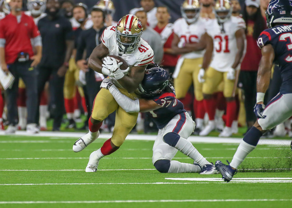 San Francisco 49ers running back Jeff Wilson gets tackled by Houston Texans defensive back Andre Chachere in a preseason game featuring lots of questionable flags. (Getty Images)