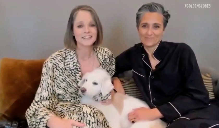 Jodie Foster and her wife, Alexandra Hedison, in pajamas with their dog on a Zoom call