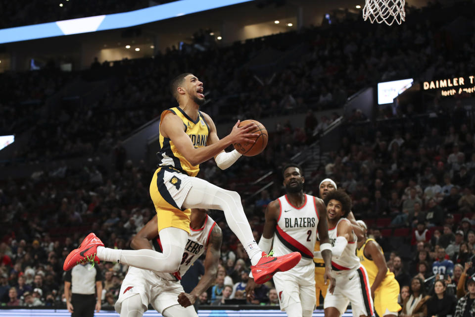 Indiana Pacers guard Tyrese Haliburton (0) reacts to a foul by Portland Trail Blazers forward Jabari Walker (34) on his way to the basket during the second half of an NBA basketball game Friday, Jan. 19, 2024, in Portland, Ore. The Trail Blazers won 118-115. (AP Photo/Amanda Loman)