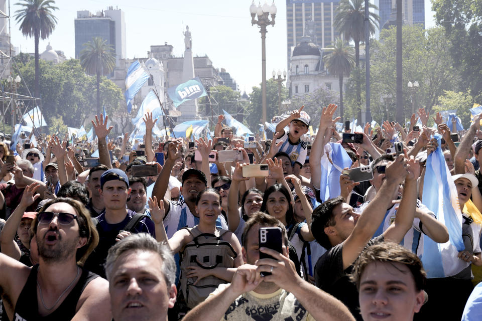 Supporters of Argentina's newly sworn-in President Javier Milei react as he talks from the balcony of the government house in Buenos Aires, Argentina, Sunday, Dec. 10, 2023.(AP Photo/Rodrigo Abd)