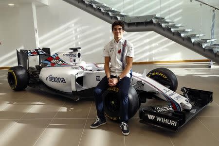 The newly announced Williams Martini Racing driver for the 2017 season Lance Stroll poses for photographers beside this years Formula 1 car at their base in Wantage, Britain November 3, 2016. REUTERS/Eddie Keogh