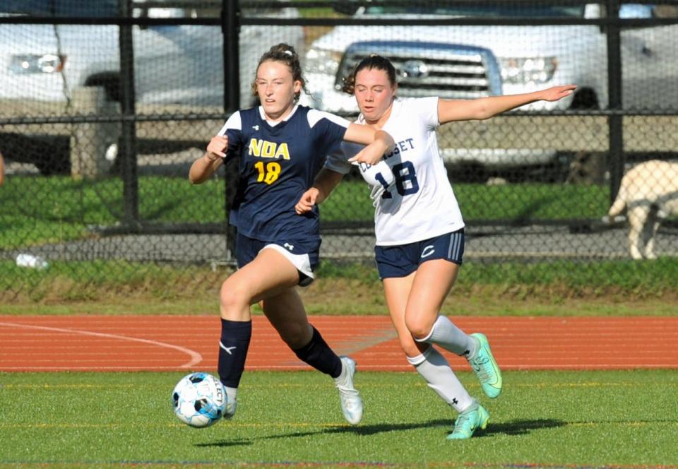 Notre Dame Academy's Sydney Comeau, left, fends off Cohasset's Riley Nussbaum, right, as she races downfield during girls high school soccer at Notre Dame Academy in Hingham, Wednesday, Sept. 14. 2022.