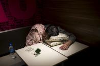 An alarm clock is seen on a table as a man sleeps on a pillow at a 24-hour McDonald's restaurant in Hong Kong, China November 11, 2015. A large number of homeless people sleeping on the street has long been been a problem in Hong Kong mainly due to its high rents and soaring property prices. In recent years, the opening of McDonald's 24-hour fast food restaurants all over the city have become popular alternatives for homeless people known as McRefugees or McSleepers to spend the night in a safer and more comfortable way than on the street. McDonaldâ€™s Hong Kong said in a statement that it is accommodating to people staying long in the restaurant for their own respective reasons, while striking a good balance to ensure that customers enjoy their dining experience.Â REUTERS/Tyrone Siu