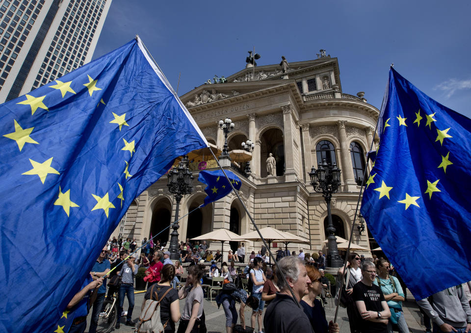 People wave European flags in front of the Old Opera during a demonstration in Frankfurt, Germany, Sunday, May 19, 2019. People across Europe attend demonstrations under the slogan 'A Europe for All - Your Voice Against Nationalism'. (AP Photo/Michael Probst)