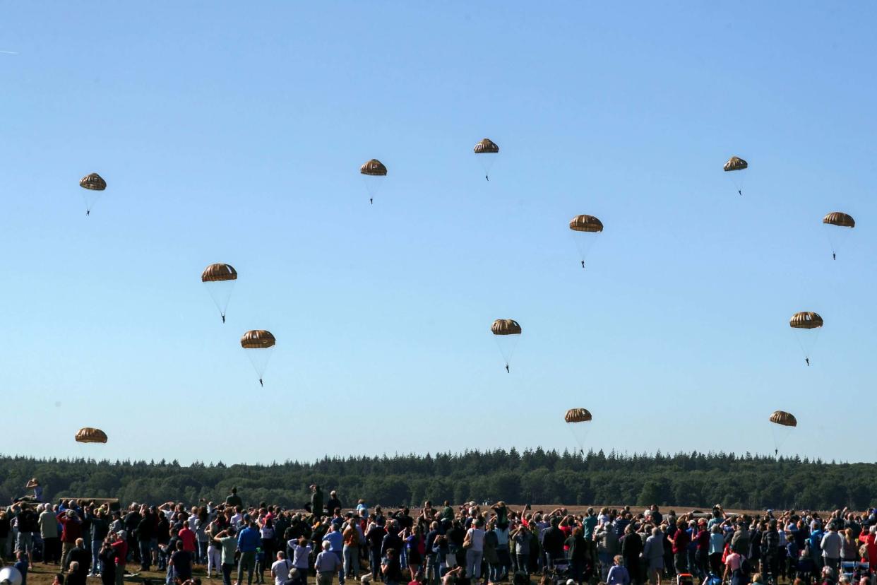 Blue skies and a large crowd at Ginkel Heath near Ede greet 1,500 paratroopers from Britain, the USA, the Netherlands and Poland: PA