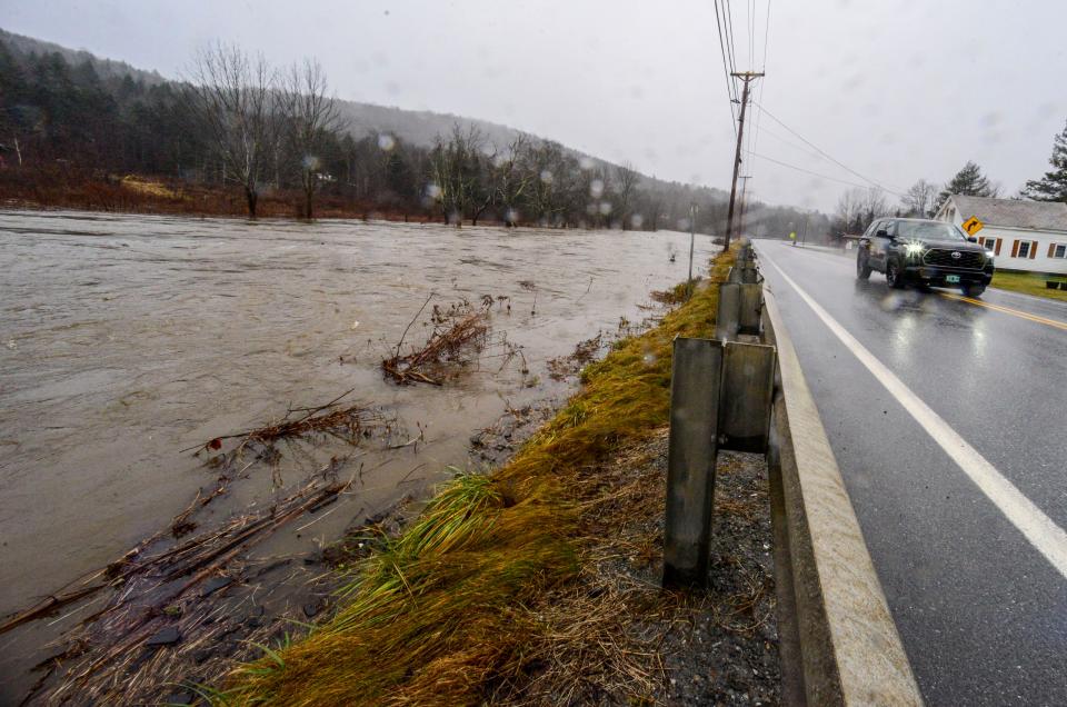 The water level of the Deerfield River creeps up to the edge of Route 100 in Wilmington, Vt., on Monday, Dec. 18, 2023, after a heavy storm dropped a couple of inches of rain. (Kristopher Radder/The Brattleboro Reformer via AP)