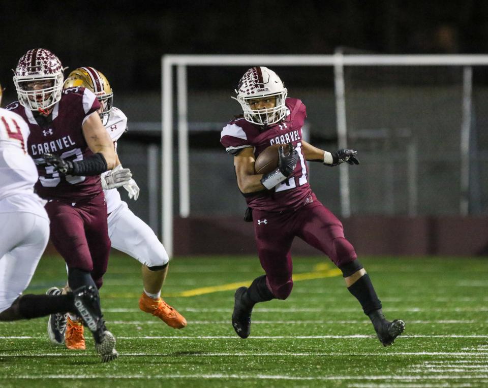 Caravel running back Craig Miller turns the corner during Caravel’s 35-0 win Thursday.