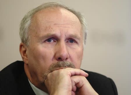 Ewald Nowotny listens during a news conference in Vienna December 15, 2014. REUTERS/Heinz-Peter Bader