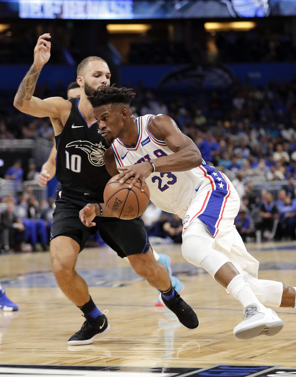 Philadelphia 76ers' Jimmy Butler (23) drives around Orlando Magic's Evan Fournier (10) during the first half of an NBA basketball game Wednesday, Nov. 14, 2018, in Orlando, Fla. (AP Photo/John Raoux)