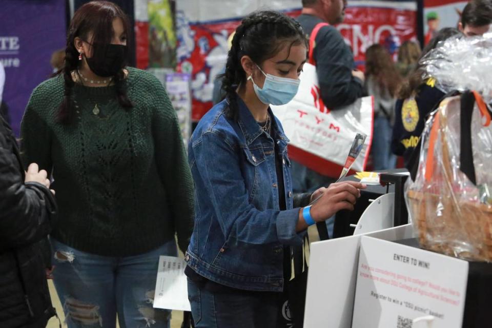 Chowchilla High School freshmen Karina Sánchez at one of the booths inside the Ag Career and Education tent at the World Ag Expo on Tuesday, Feb. 8, 2022. 