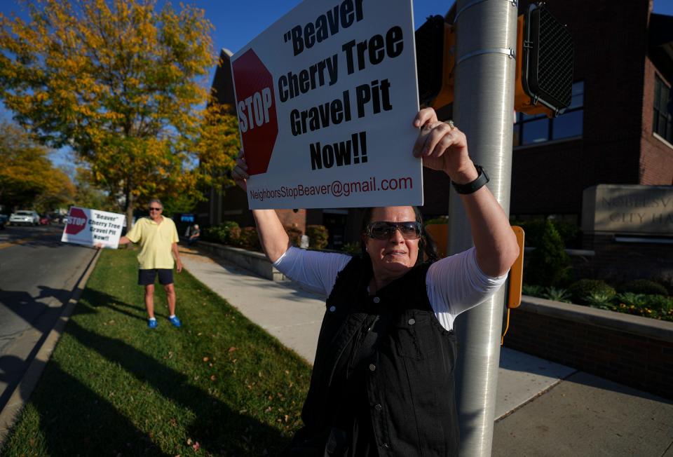 P.J. Adams holds a protest sign Monday, Oct. 2, 2023, before a Noblesville Zoning Board of Appeals meeting at Noblesville City Hall. Adams was among residents protesting a gravel pit that Beaver Materials wants to build northwest of 161st Street and Cherry Tree Road. "This is the first time I've ever protested anything," Adams said. "This is so horrible." Adams said she worries about the dust and noise affecting children and elderly people who live in the adjacent development.