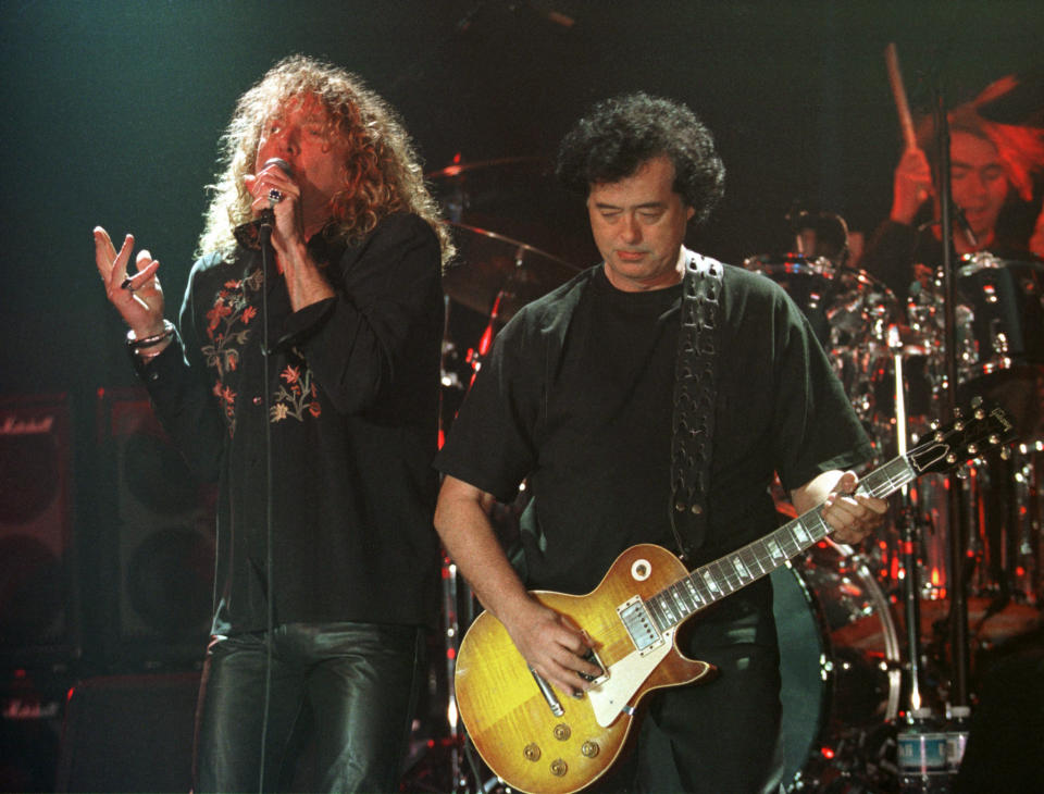 FILE--In this March 5, 1998, file photo, Led Zeppelin's Robert Plant, left, performs with guitarist Jimmy Page during their concert in Istanbul. A U.S. appeals court on Friday, Sept. 28, 2018, ordered a new trial in a lawsuit accusing Led Zeppelin of copying an obscure 1960s instrumental for the intro to its classic 1971 rock anthem "Stairway to Heaven." (AP Photo/Murad Sezer, File)