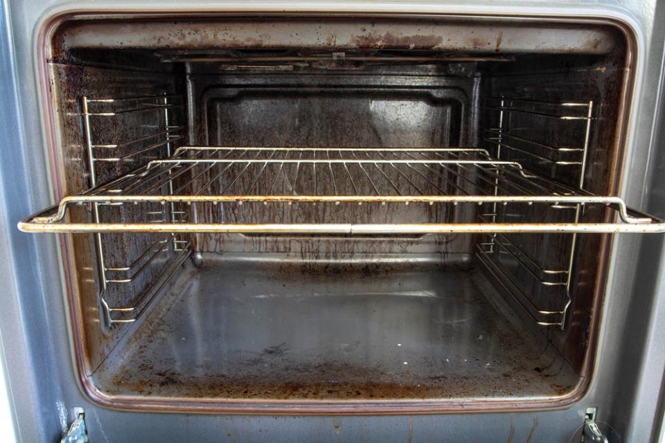 Interior view of a dirty oven. 