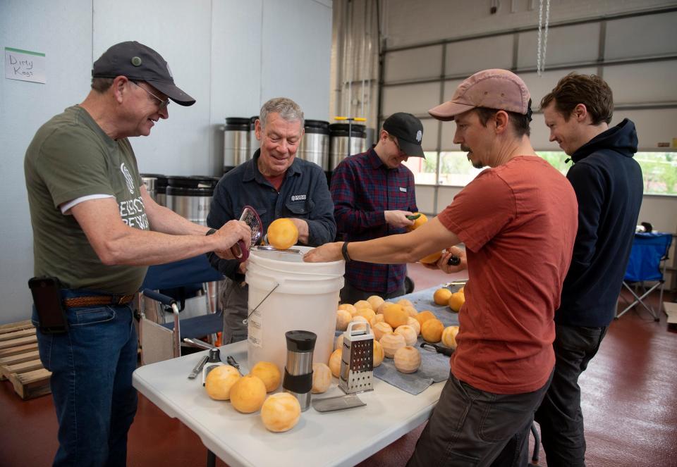 Mike Adams, Chuck Tipton, Ryan Tipton, Benjamin Tipton and Seth Tipton work on zesting five pounds of fresh grapefruit at Bell Tower Brewing Co. in Kent. Co-owner Ryan Tipton's dad, Chuck, is using a method of zesting seen on YouTube.