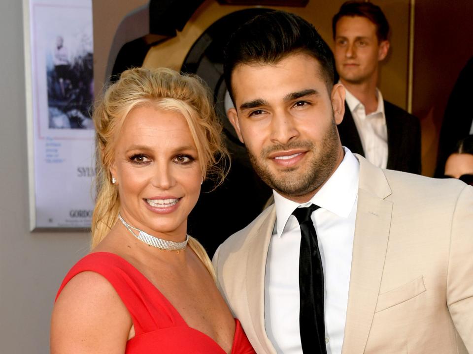 Britney Spears and Sam Asghari on a red carpet in 2019.