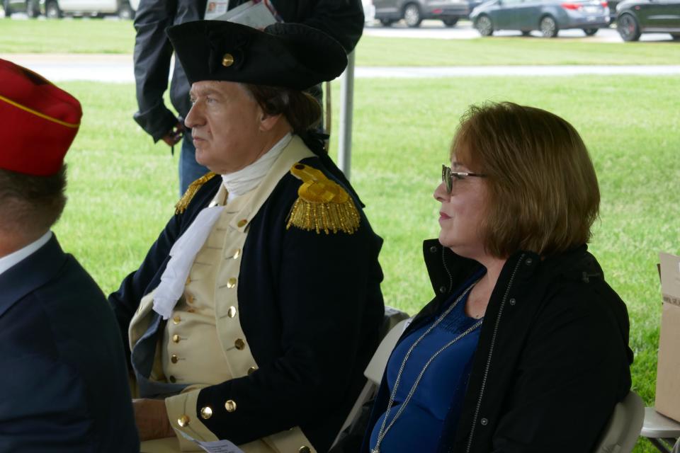 Gen. George Washington re-enactor John Goczieba and sculptor Jennifer Frudakis-Petry listen to the ceremony honoring the unveiling of the statue of Washington that Frudakis-Petry made at Washington Crossing National Cemetery.