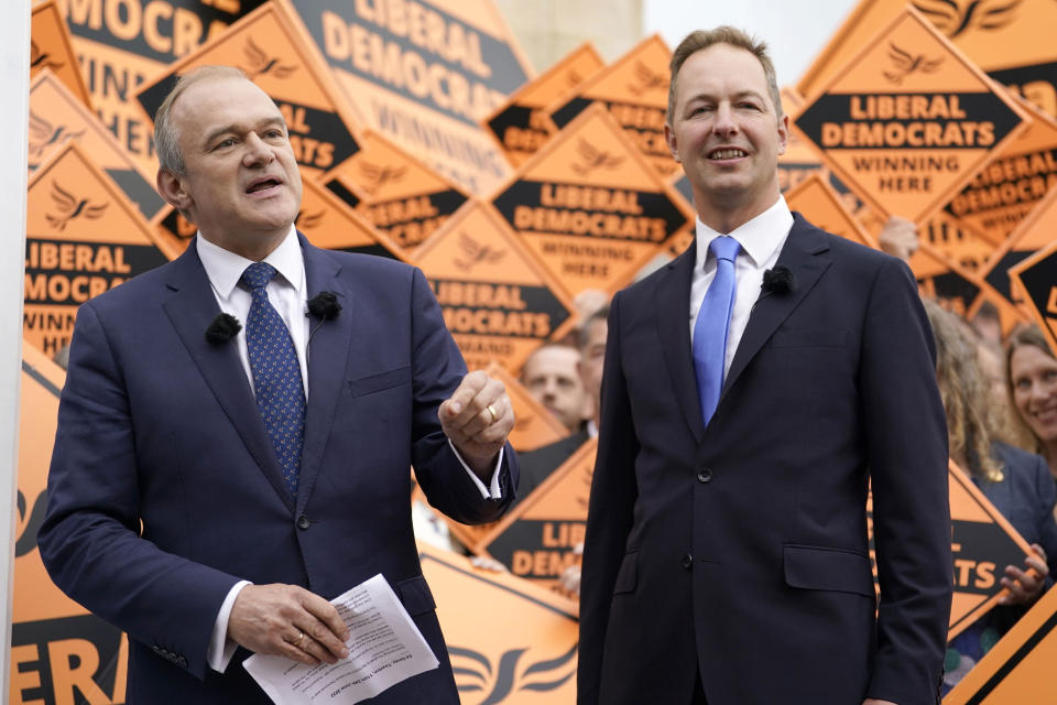 Liberal Democrat Leader Ed Davey, left, celebrates with Richard Foord, right, the newly-elected Liberal Democrat lawmaker for Tiverton and Honiton, in Crediton, England, Friday June 24, 2022. British Prime Minister Boris Johnson suffered a double blow as voters rejected his Conservative Party in two special elections dominated by questions about his leadership and ethics. The centrist Liberal Democrats overturned a big Conservative majority to win the rural south west England seat of Tiverton and Honiton, while the main opposition Labour Party reclaimed Wakefield in northern England from Johnson's Tories. (Andrew Matthews/PA via AP)