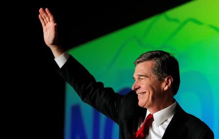 Roy Cooper, North Carolina candidate for governor, waves to supporters during an election night party in Raleigh, North Carolina, U.S. November 9, 2016. REUTERS/Chris Keane