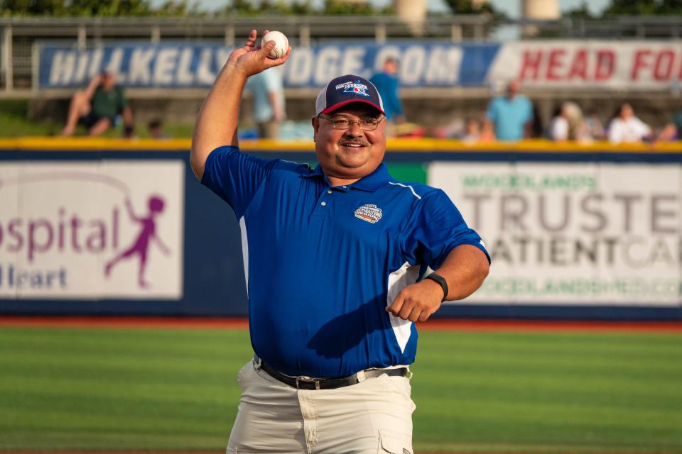 Bill Vikara, a Little League Baseball association umpire, throws out a ceremonial first pitch at a Blue Wahoos game in honor of working the 75th Little League World Series that begins Wednesday.