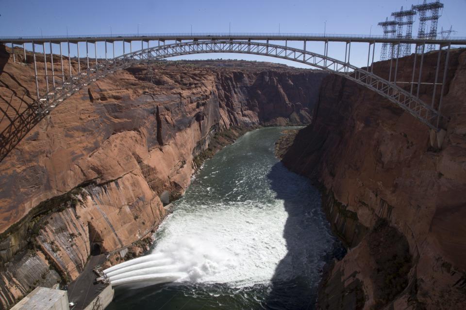 Water is released from Glen Canyon Dam through a bypass tube on Nov. 5, 2018, during a high-flow experiment. The flood will help move sand and sediment down the Colorado River the way the river's natural flows did before construction of Glen Canyon Dam.