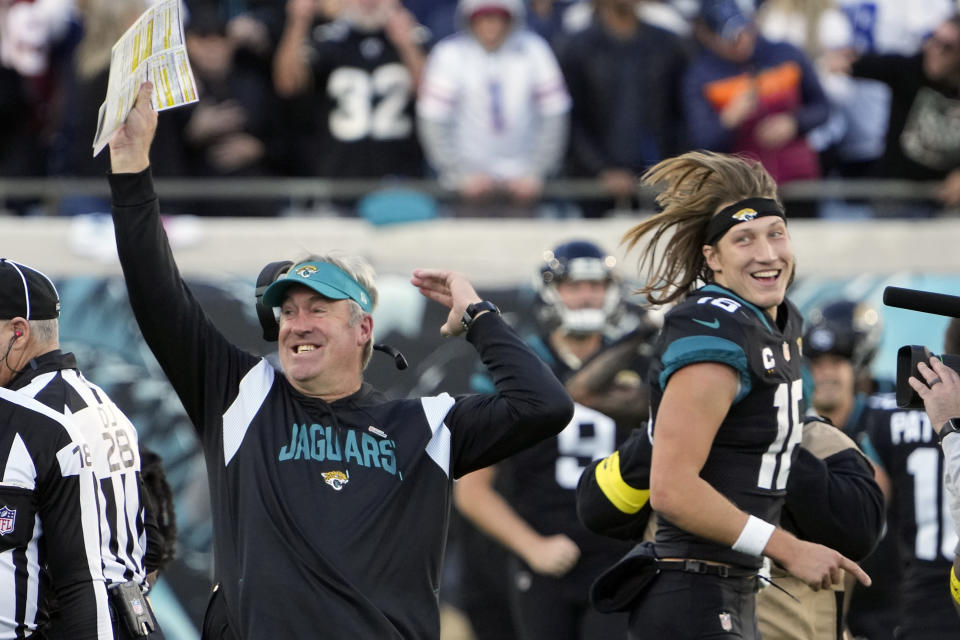 Jacksonville Jaguars head coach Doug Pederson, left, celebrates with Jacksonville Jaguars quarterback Trevor Lawrence (16) after defeating the Dallas Cowboys in overtime in an NFL football game, Sunday, Dec. 18, 2022, in Jacksonville, Fla. (AP Photo/John Raoux)