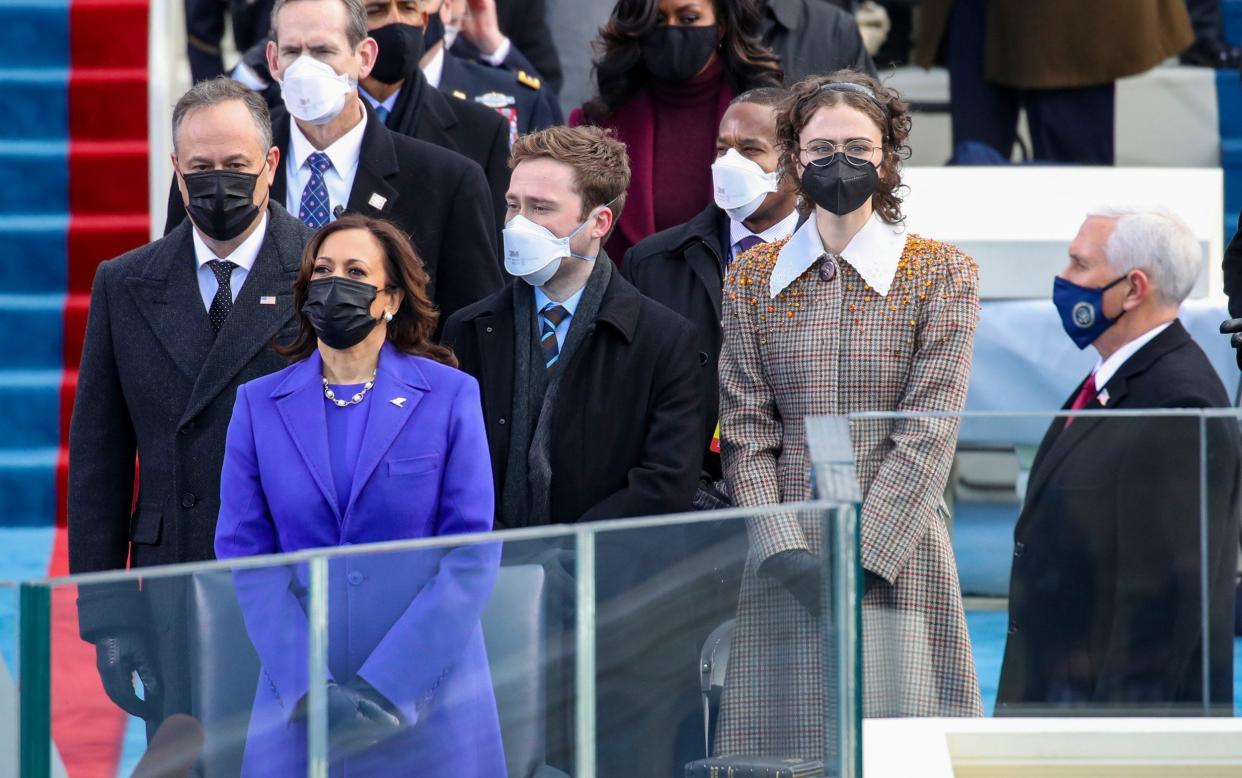 Ella Emhoff and her family stand at Joe Biden's inauguration in 2021, wearing facemasks