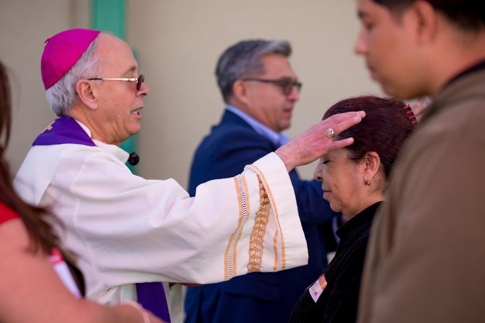 Catholics receive ashes on their forehead from Bishop Mark J. Seitz, who conducted a worship service on Ash Wednesday at the El Pasoans Fighting Hunger Food Bank on Wednesday, Feb. 14, 2024.