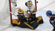 Pittsburgh Penguins goaltender Tristan Jarry has the puck bounce off him in the third period of an NHL hockey game against the Colorado Avalanche Wednesday, March 22, 2023, in Denver. (AP Photo/David Zalubowski)