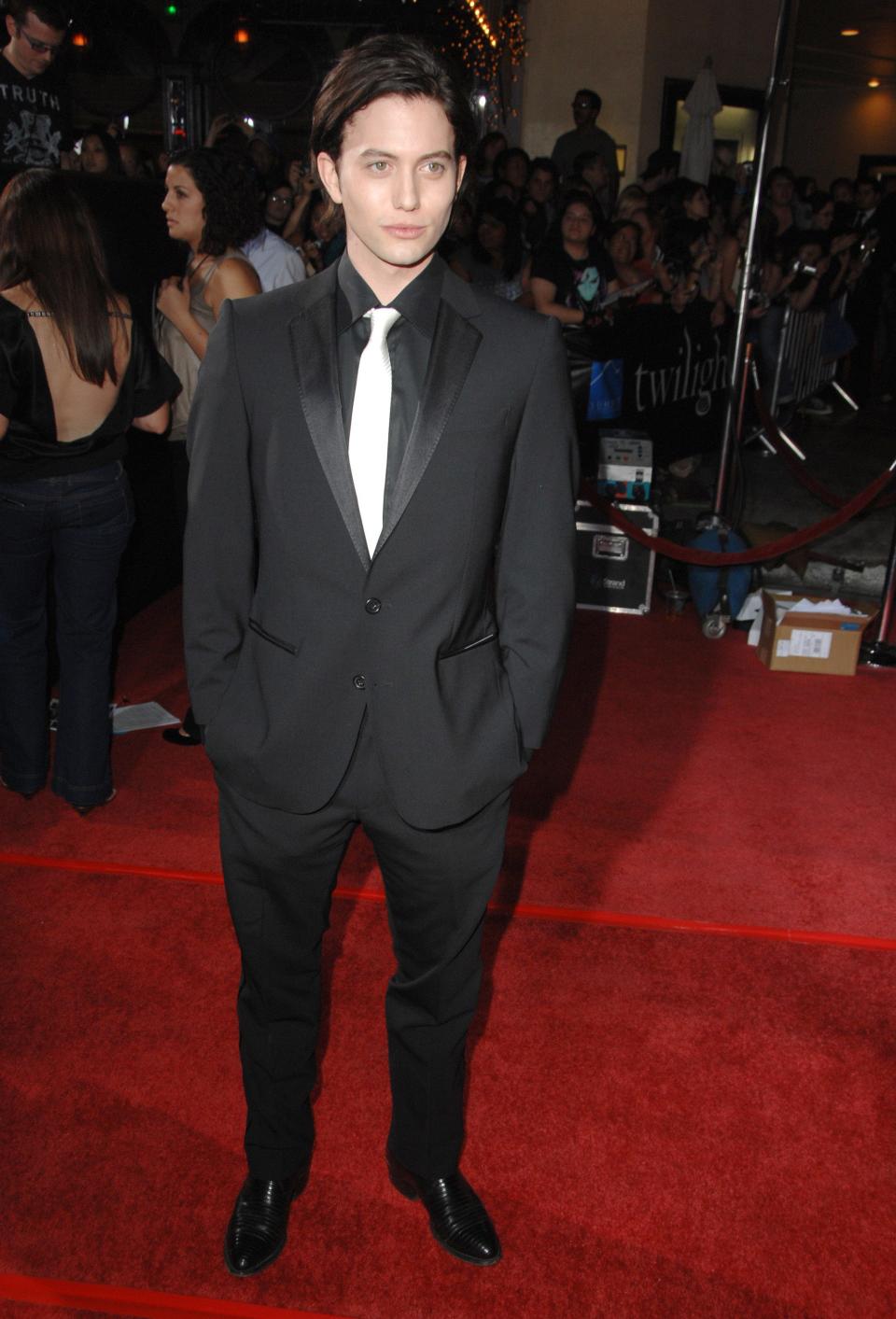 Jackson Rathbone in a black suit and silver tie