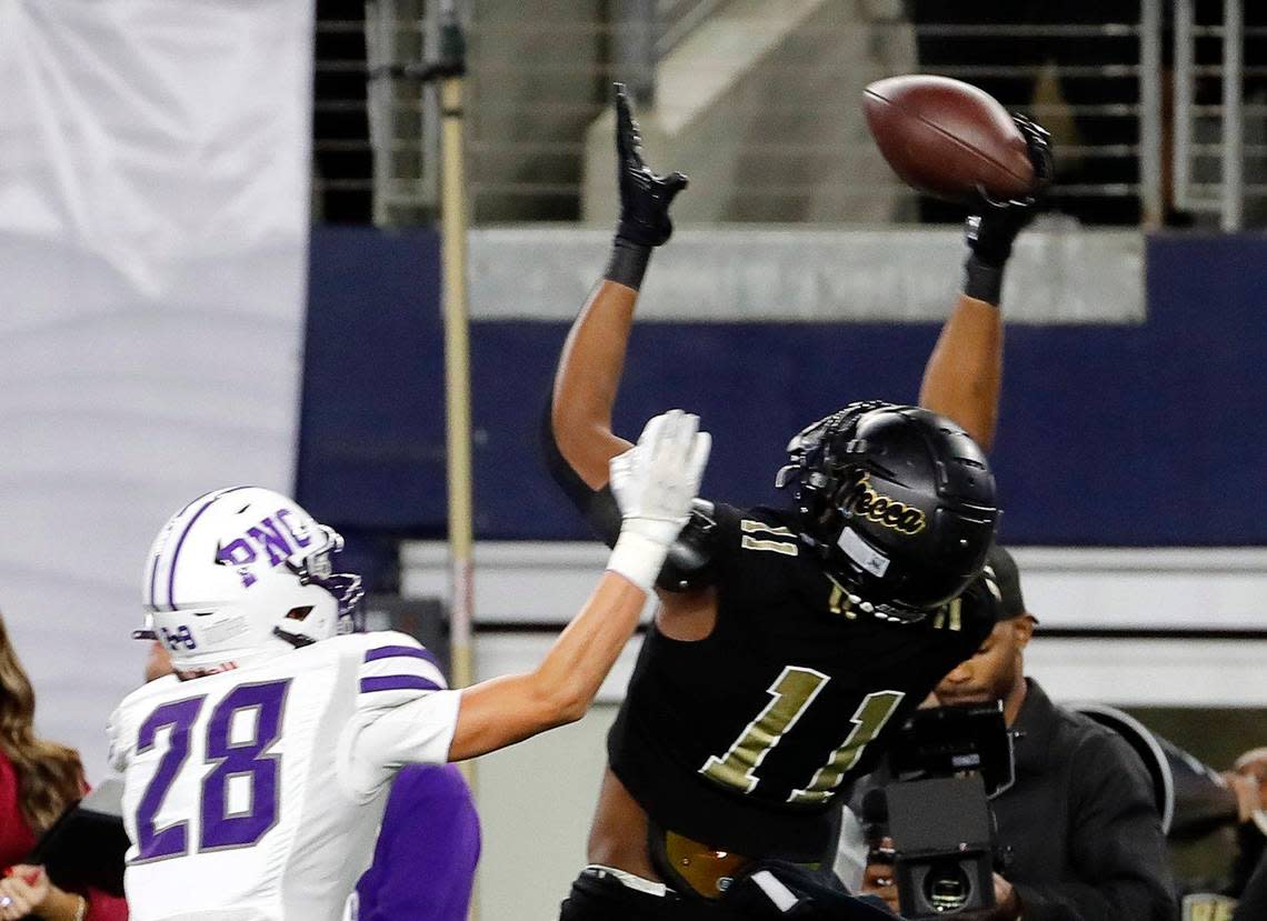 South Oak Cliff wide receiver Jamyri Cauley (11) grabs a pass in front of Port Neches-Grove defensive back Reid Richard (28) in the first half of a UIL Class 5A D2 state championship football game at AT&T Stadium in Arlington, Texas, Friday, Dec. 16, 2022. Port Neches-Grove led South Oak Cliff 71-12 at the half. (Star-Telegram Bob Booth)