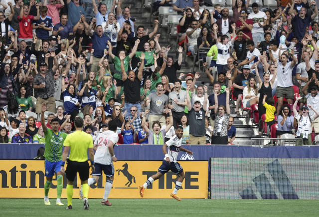 Vancouver Whitecaps' Pedro Vite, back right, and Brian White (24) celebrate Vite's goal against the Seattle Sounders during the first half of an MLS soccer match in Vancouver, British Columbia on Saturday, May 20, 2023. (Darryl Dyck/The Canadian Press via AP)