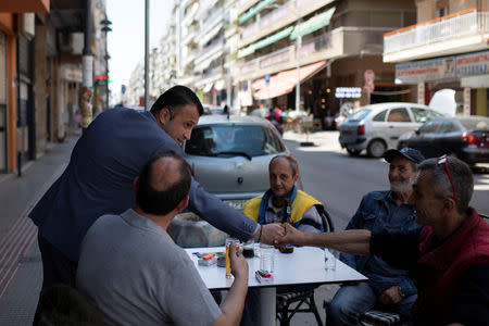 FILE PHOTO: Undertaker and candidate for town councillor at the municipality of Sykies, Konstantinos Baboulas, greets locals next to his family's funeral parlor in Thessaloniki, Greece, May 17, 2019. REUTERS/Alkis Konstantinidis