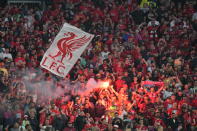Liverpool fans light flares prior to the start of the Champions League final soccer match between Liverpool and Real Madrid at the Stade de France in Saint Denis near Paris, Saturday, May 28, 2022. (AP Photo/Kirsty Wigglesworth)