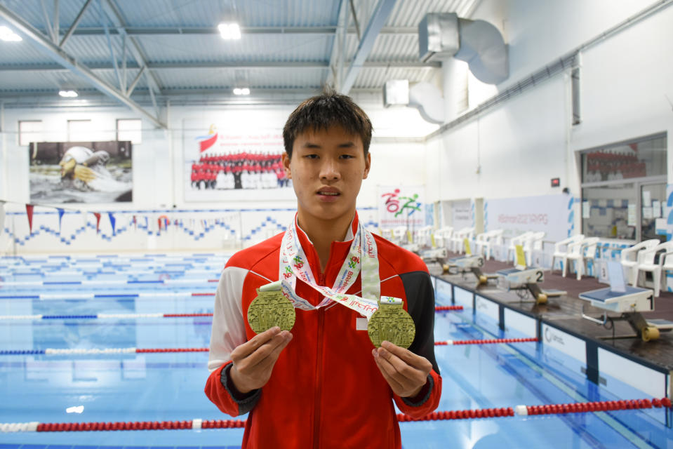 Para-swimmer Colin Soon with his two golds won at the 2021 Asian Youth Para Games in Bahrain. (PHOTO: Singapore National Paralympic Council)