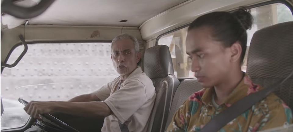 Pak Man scolds Amir for meddling with his things in his truck in a new Hari Raya themed short film PLUS. — Screengrab via Youtube/PLUS TV