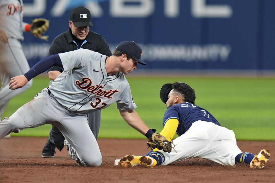 Tampa Bay Rays' Jose Caballero steals second base ahead of the tag by Detroit Tigers second baseman Colt Keith (33) during the third inning of a baseball game Tuesday, April 23, 2024, in St. Petersburg, Fla. (AP Photo/Chris O'Meara)