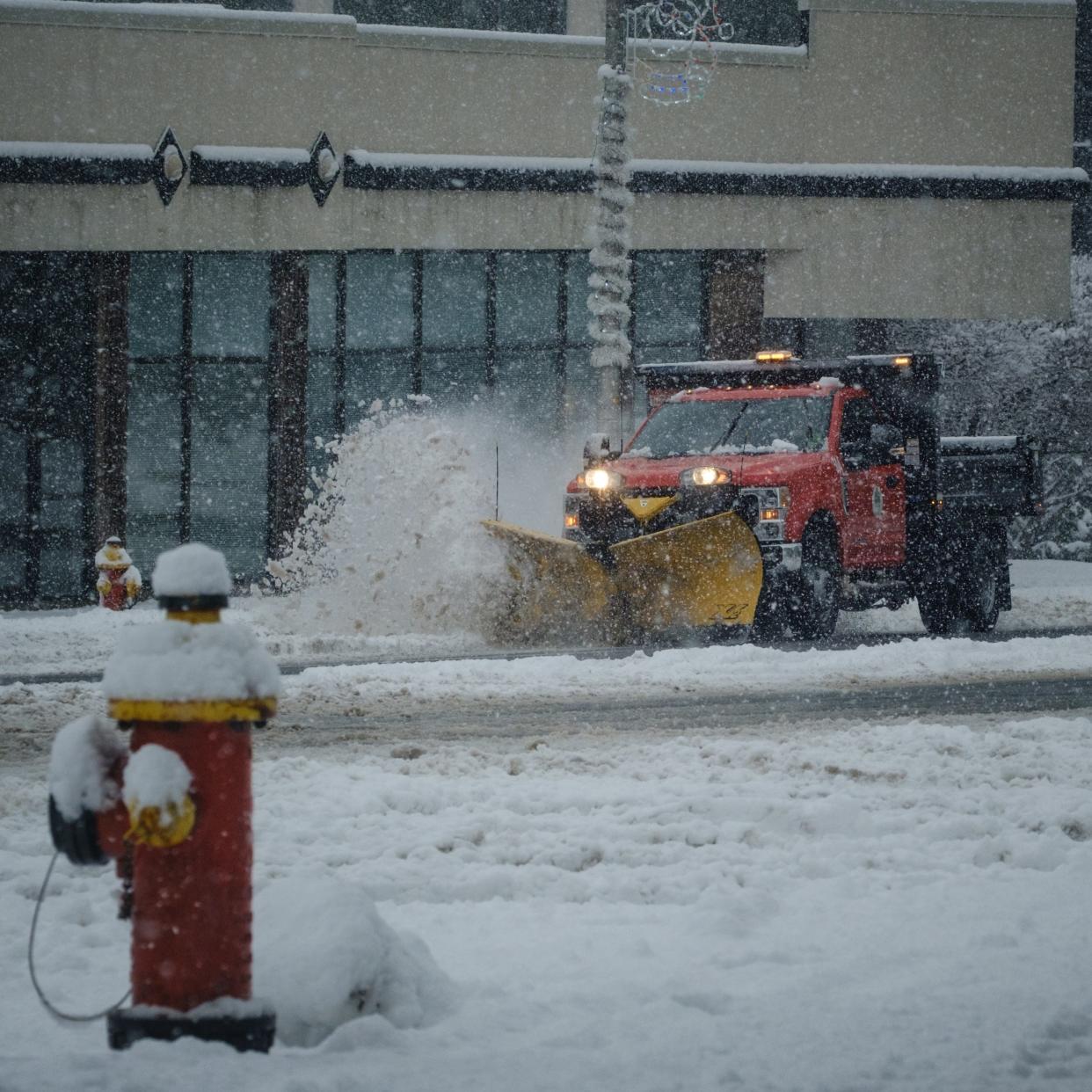 A snow plow is put to work on Genesee Street in downtown Utica on Friday, December 16, 2022.