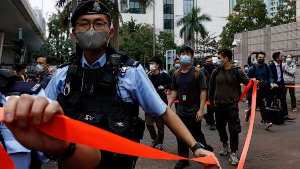 PHOTO: Police ask supporters to leave the entrance of West Kowloon Magistrates' Courts building during the hearing of the 47 pro-democracy activists charged with conspiracy to commit subversion under the national security law, in Hong Kong, Feb. 6, 2023. (Tyrone Siu/Reuters)