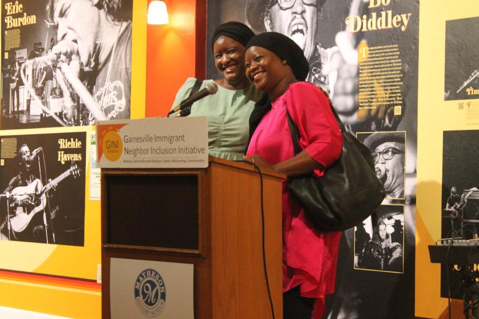 Awa Kaba, left, and Aisse Kane, right, co-owners of Flavorful, which specializes in African fusion cuisine, speak at the Gainesville Immigrant Neighbor Inclusion Initiative's 3rd anniversary celebration on Friday.
(Credit: Photo by Voleer Thomas/For The Guardian)