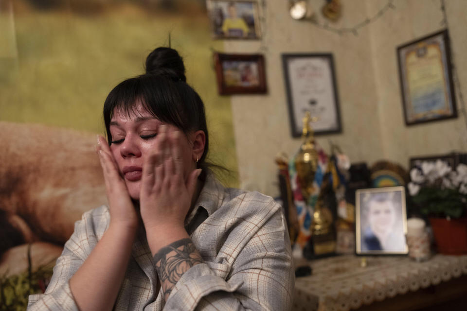 Polina Ihrak cries after returning home from a boxing tournament in honor of her life partner, Maksym Halinichev, who was killed during fighting with Russian forces in March 2023, in Shostka, Sumy region, Ukraine on Sunday, Feb. 4, 2024. “He believed he had to return to his brothers in arms because he was needed,” says Ihrak. (AP Photo/Evgeniy Maloletka)