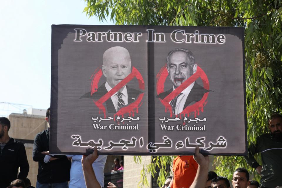 2023年10月18日，約旦首都安曼，抗議者舉著拜登與納坦雅胡的牌子，控兩人是戰犯。路透社