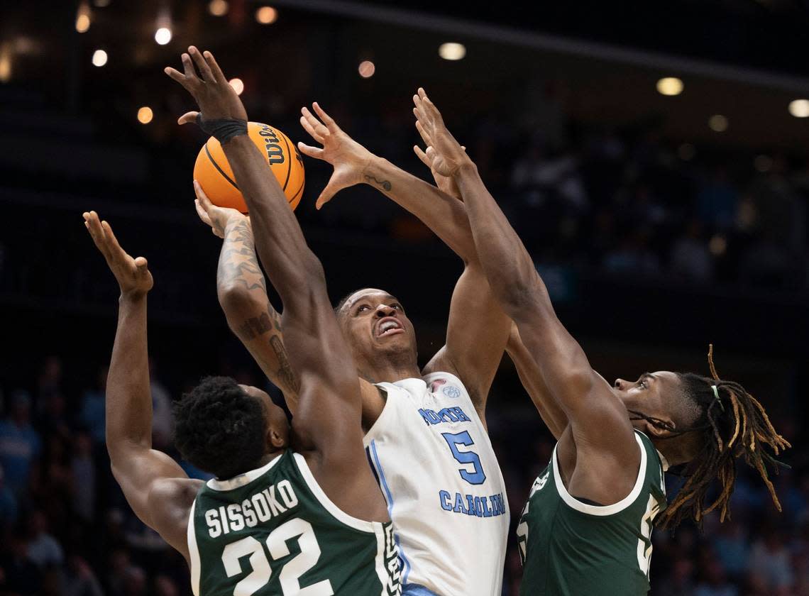 North Carolina’s Armando Bacot (5) puts up a shot against Michigan State’s Mady Sissoko (22) and Coen Carr (55) during the first half on Saturday, March 23, 2024, during the second round of the NCAA Tournament at Spectrum Center in Charlotte, N.C.