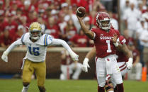 Oklahoma quarterback Kyler Murray (1) throws in front of UCLA linebacker Jaelan Phillips (15) in the first quarter of an NCAA college football game in Norman, Okla., Saturday, Sept. 8, 2018. (AP Photo/Sue Ogrocki)