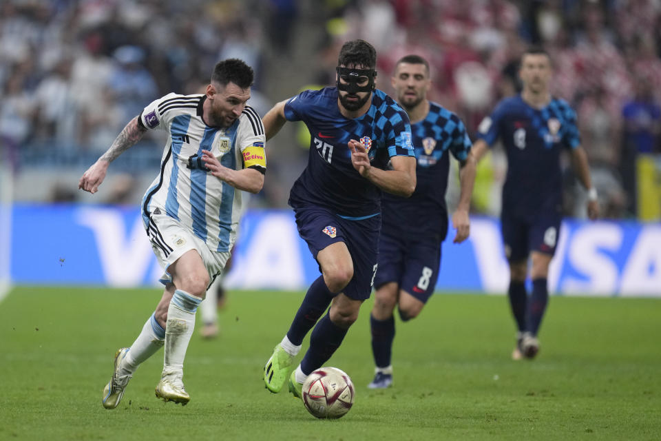 Argentina's Lionel Messi in action in front of Croatia's Josko Gvardiol during the World Cup semifinal soccer match between Argentina and Croatia at the Lusail Stadium in Lusail, Qatar, Tuesday, Dec. 13, 2022. (AP Photo/Manu Fernandez)
