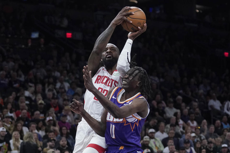 Houston Rockets forward Jeff Green, top, drives to the basket against Phoenix Suns center Bol Bol (11) during the first half of an NBA basketball game in Phoenix, Saturday, March. 2, 2024. (AP Photo/Darryl Webb)