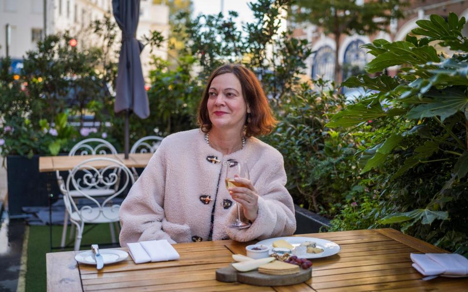 Liz enjoys a glass of wite wine with lunch