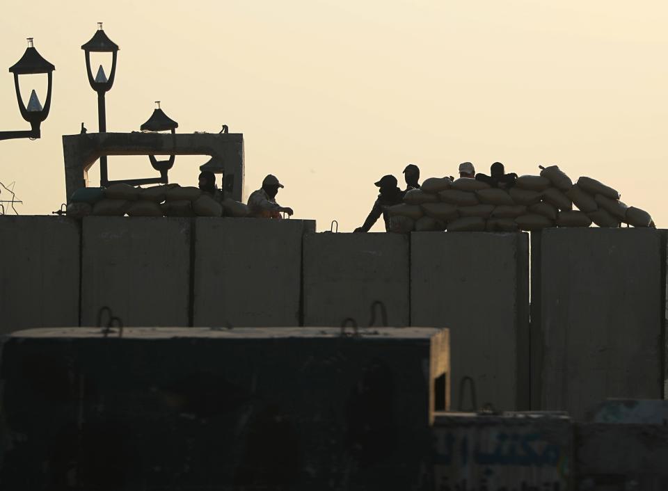 Iraqi security forces close a bridge leading to the Green Zone government areas during ongoing anti-government protests, in Baghdad, Iraq, Tuesday, Nov. 5, 2019. (AP Photo/Hadi Mizban)