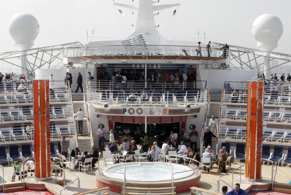 HAMBURG, GERMANY - APRIL 24: A view on the deck with the poolbar on board the "Freedom of the Seas", the world's largest cruise ship, docked on April 24, 2006 in Hamburg, Germany. The flagship of the Norwegian-American company Royal Caribbean International can accommodate up to 4,370 passengers and 1,360 crew members. The Finnish-built vessel is stopping over at the Northern German port to receive finishing touces at the Blohm and Voss shipyard, before setting sail for its maiden transatlantic voyage. (Photo by Lutz Bongarts/Getty Images)